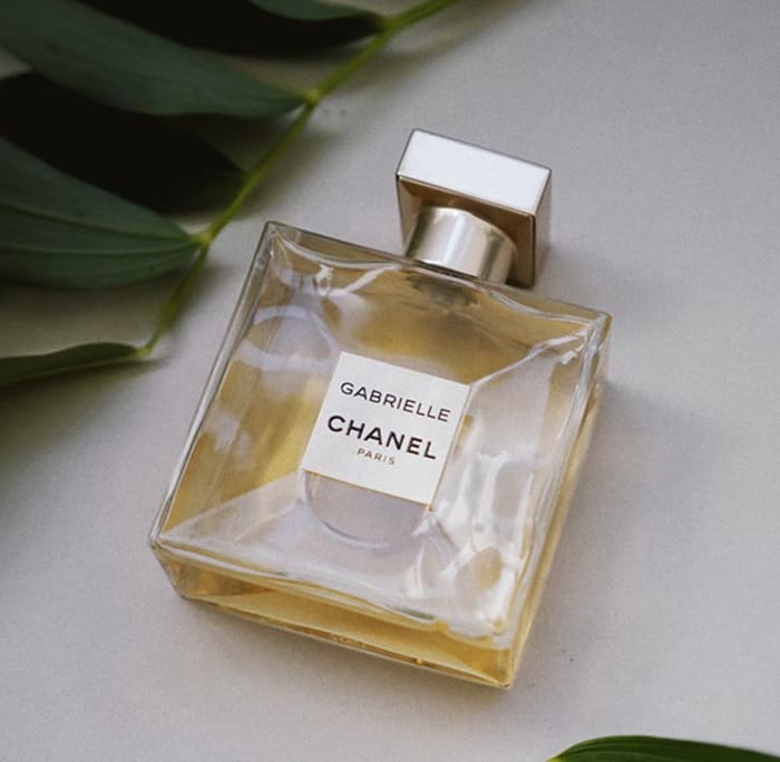 an elegant bottle of Gabrielle Essence Eau De Parfum laid beautifully on a table